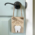 tooth fairy door hanger is hanging on a door and made of wood laser engraved with tooth fairy stop here has a section for a child to insert a tooth and for the tooth fairy to insert money