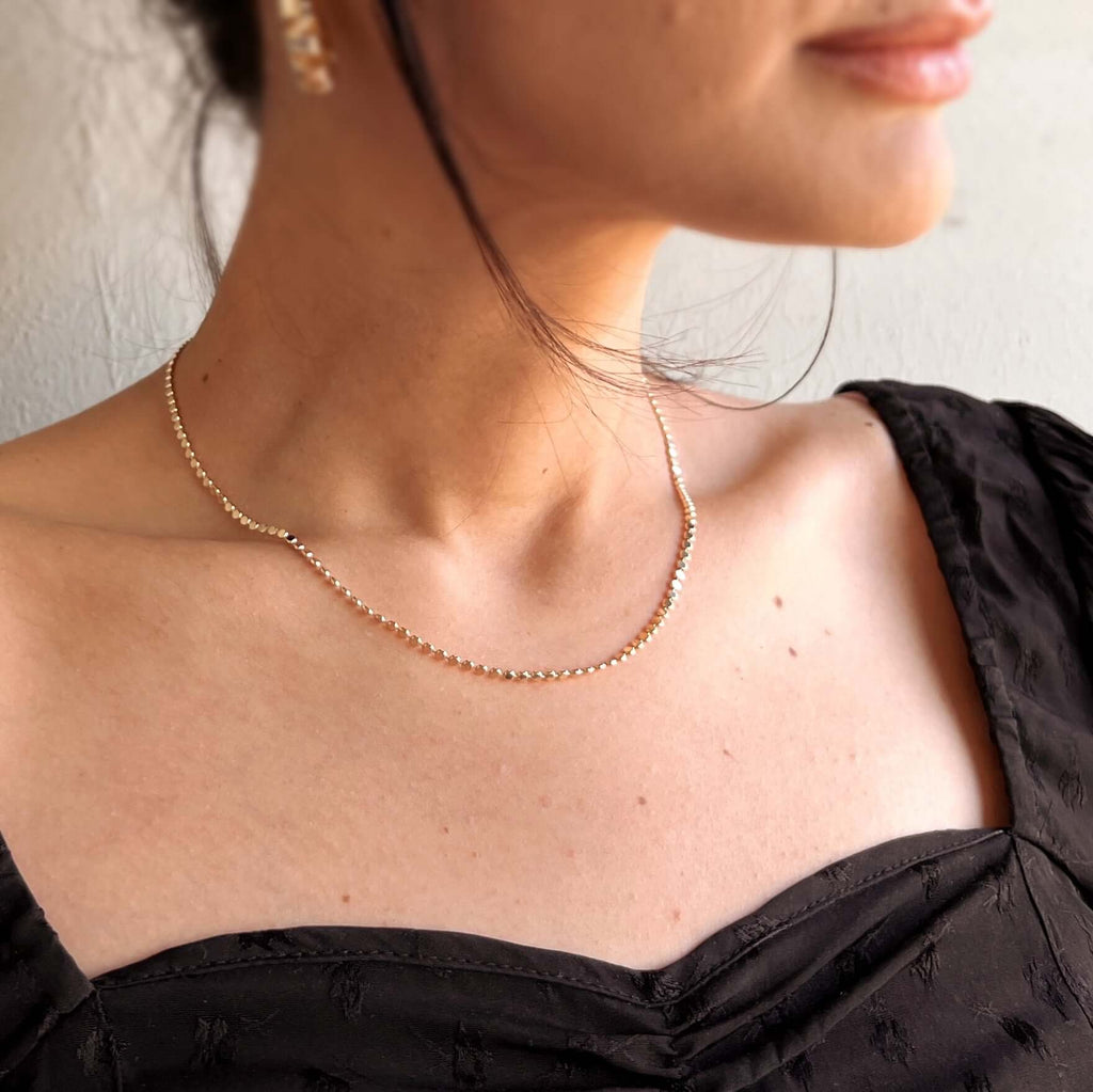 model wearing tarnish free flat ball 18 karat gold filled necklace