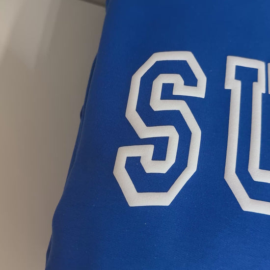 Short video showcasing the white puff look on royal blue hoodies with