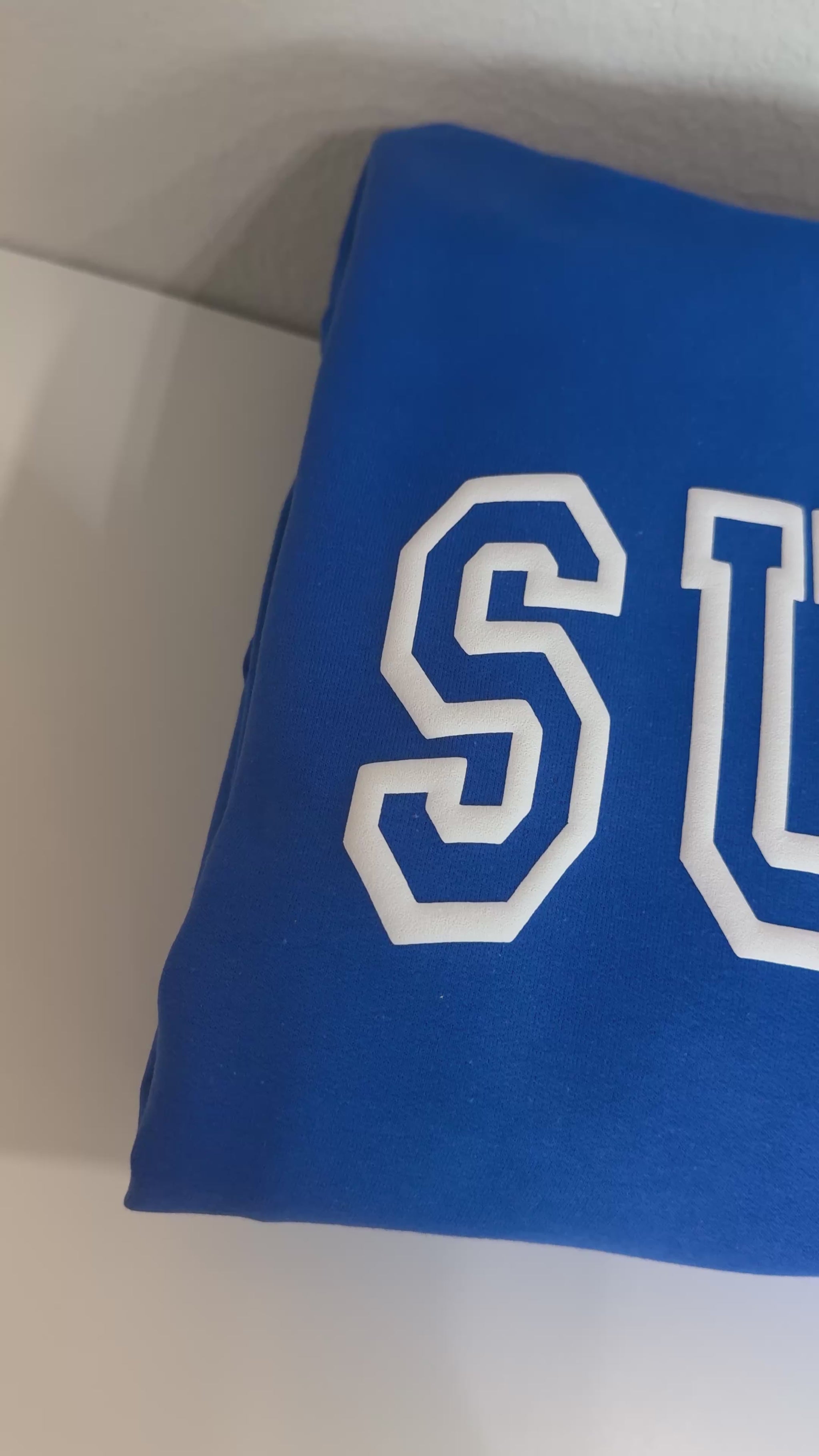 Short video showcasing the white puff look on royal blue hoodies with